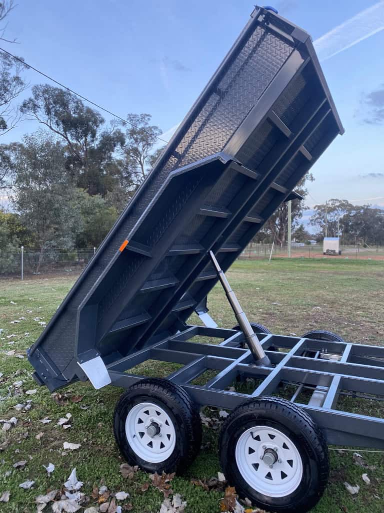 Hydraulic dump trailer with raised bed.